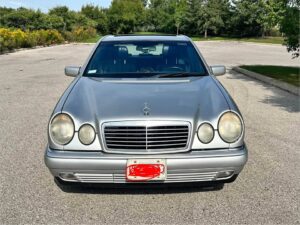 Silver 1997 Mercedes-Benz E300 Diesel in a parking lot, front view showing the twin oval headlights