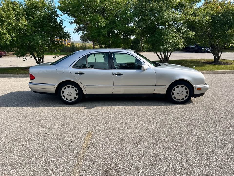 Side profile of the silver E300 Diesel on factory alloy wheels