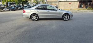 Silver 2005 Mercedes-Benz E320 CDI in a parking lot, rear three-quarter view