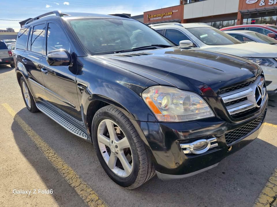 Black 2009 Mercedes-Benz GL 320 BlueTEC, front three-quarter view in a Calgary parking lot
