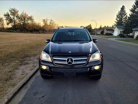 Black 2010 Mercedes-Benz GL 320 CDI on a residential street in Prince Albert, front view at dusk