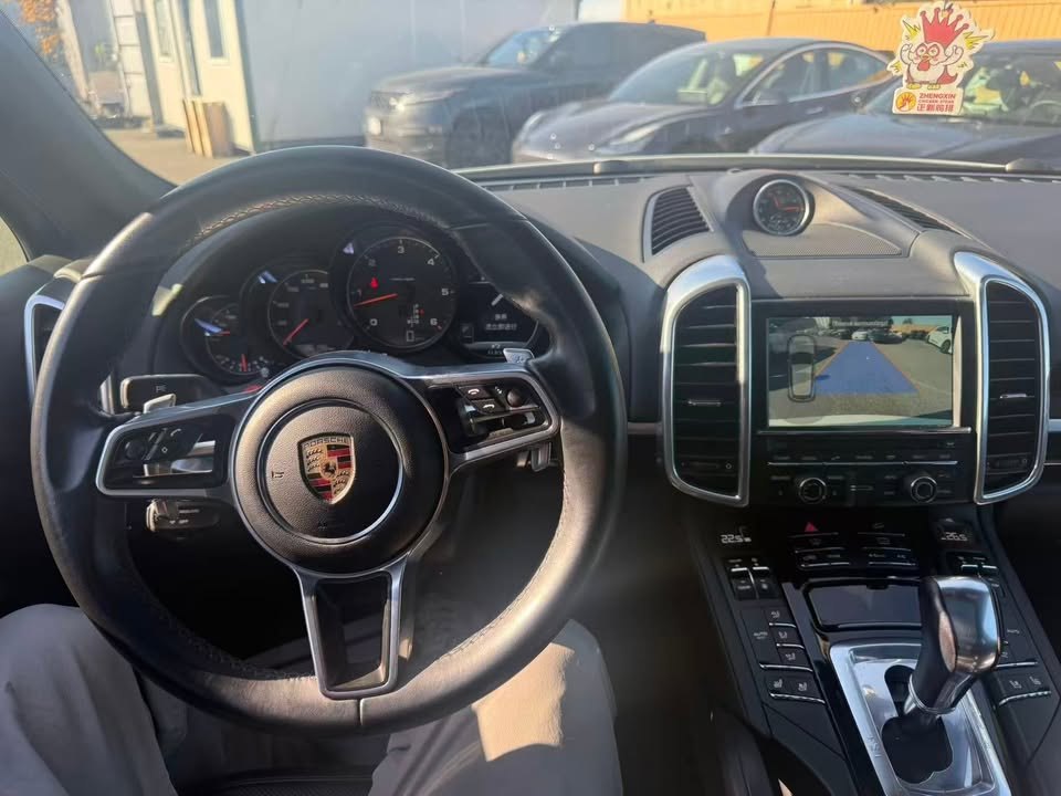 Steering wheel and gauges with the reversing camera showing on the centre screen