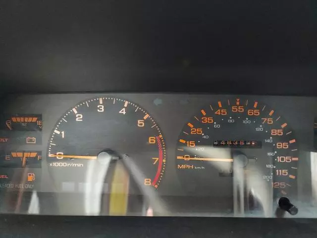 Instrument cluster of the 1987 Nissan 200SX XE with orange tachometer and speedometer markings